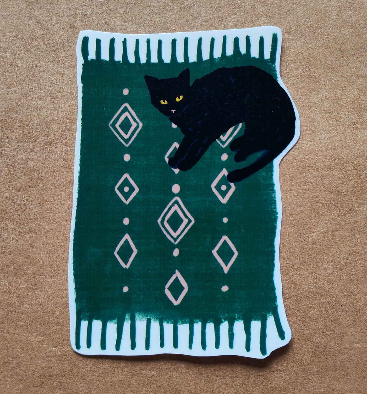 Black cat on green rug sticker